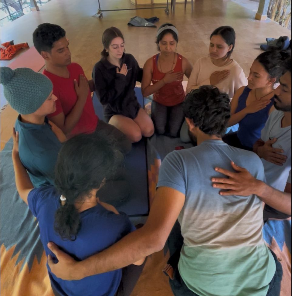 A small group, hands resting on each other's hearts