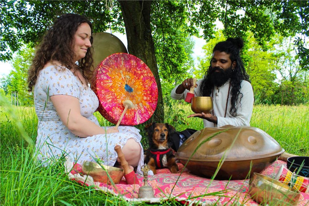 Sound bowls and a gong under a tree